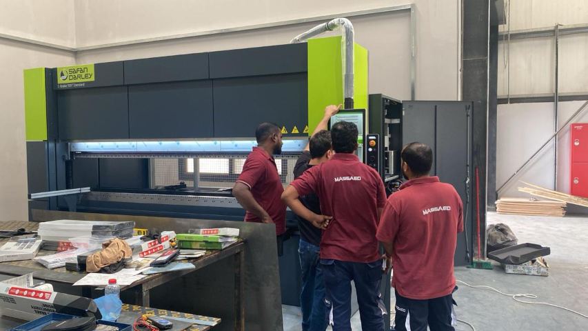 Fabrication team at the CNC press brake control panel