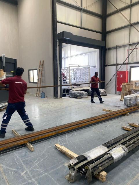 MASSAED team moving long steel sections across the production hall